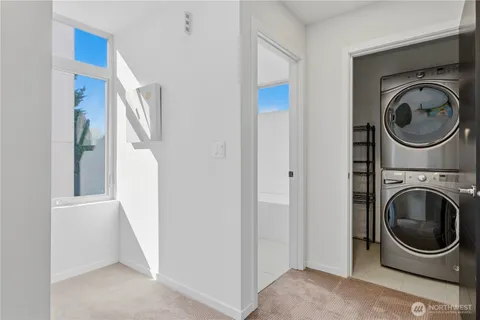 a view of a storage and utility room with washer and dryer