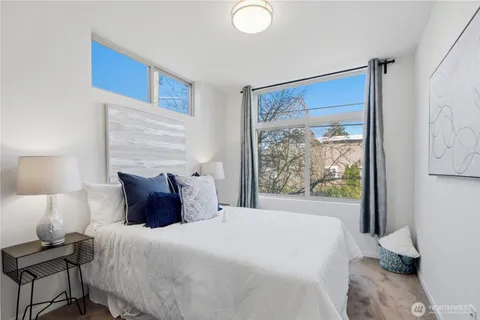 a bedroom with a large bed and a window