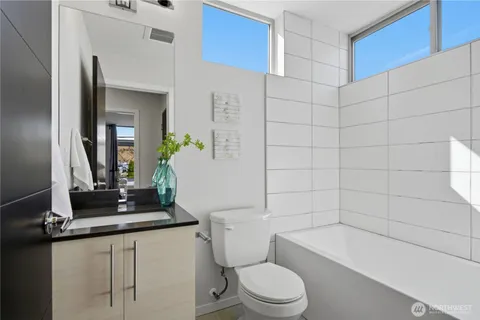 a bathroom with a toilet a sink and bathtub