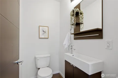 a bathroom with a toilet sink and vanity