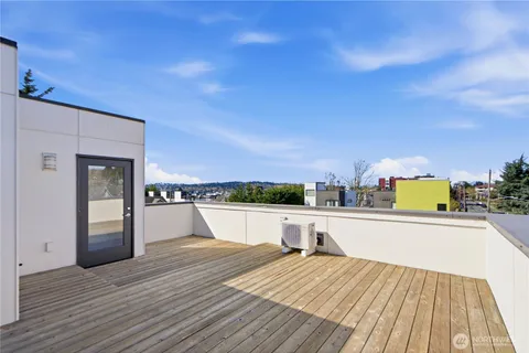 a view of a terrace with wooden floor and flat screen tv