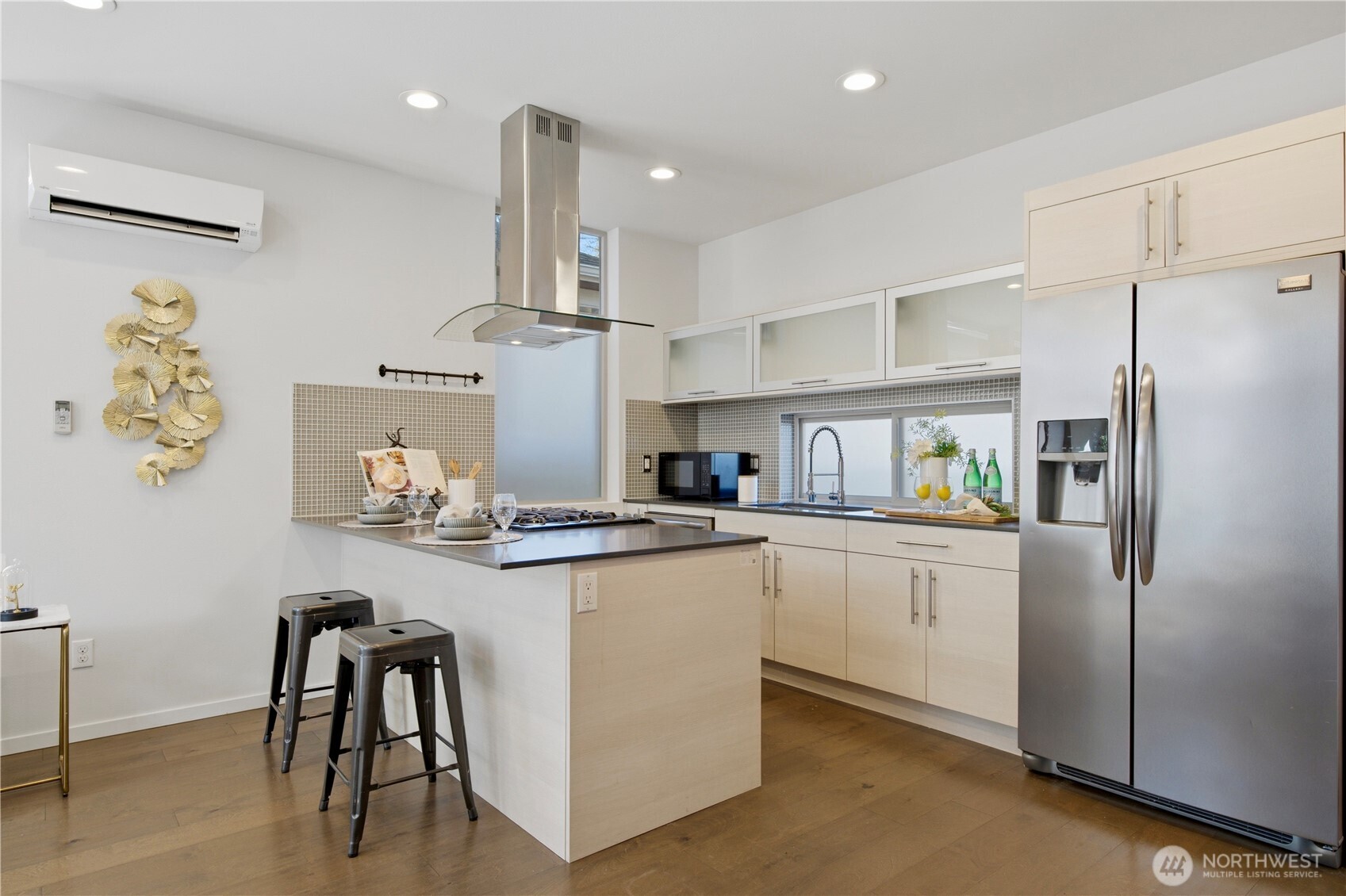 2033 Northwest 65th Street Seattle, WA 98117 - Photo 4 of 20 a kitchen with white cabinets and stainless steel appliances