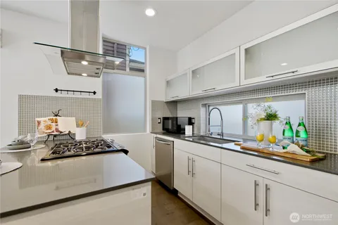 a kitchen with stainless steel appliances a sink stove and cabinets