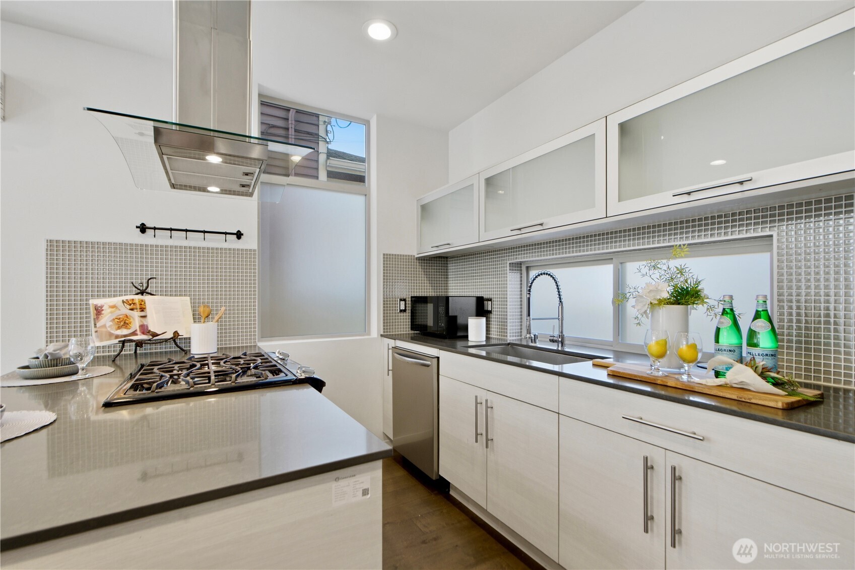 2033 Northwest 65th Street Seattle, WA 98117 - Photo 5 of 20 a kitchen with stainless steel appliances a sink stove and cabinets