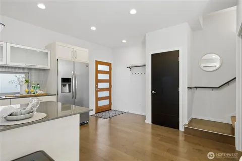 a kitchen with stainless steel appliances granite countertop a refrigerator and a sink