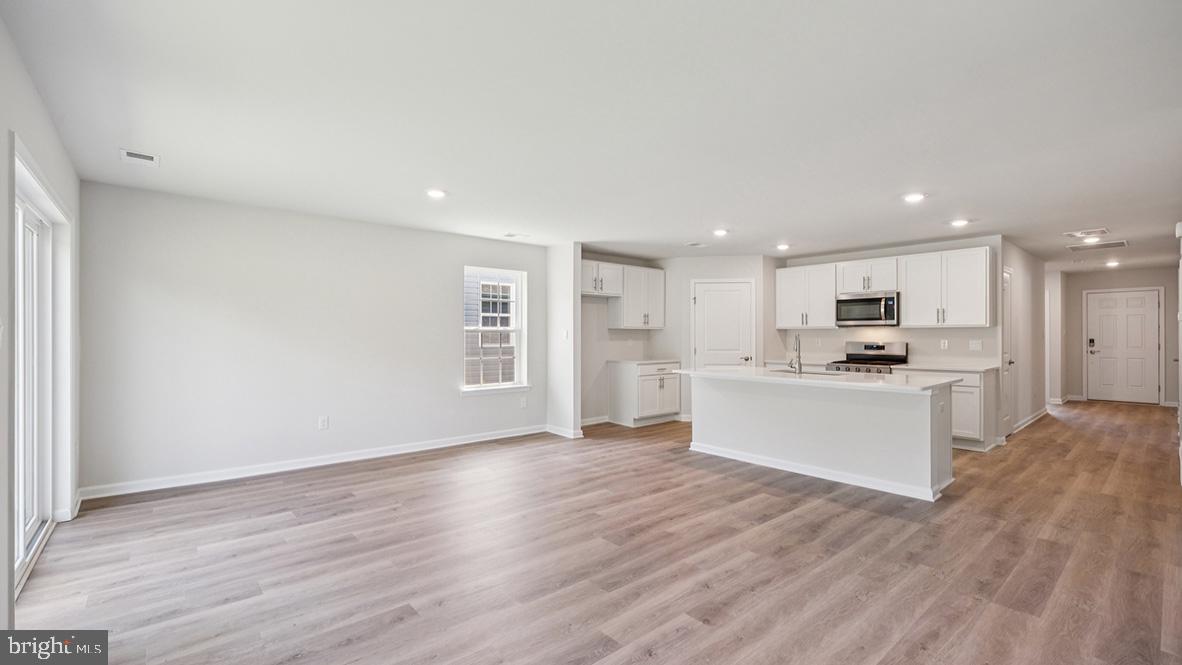 311 Vero Road Egg Harbor Township, NJ 08234 - Photo 17 of 27 a view of kitchen with wooden floor and window