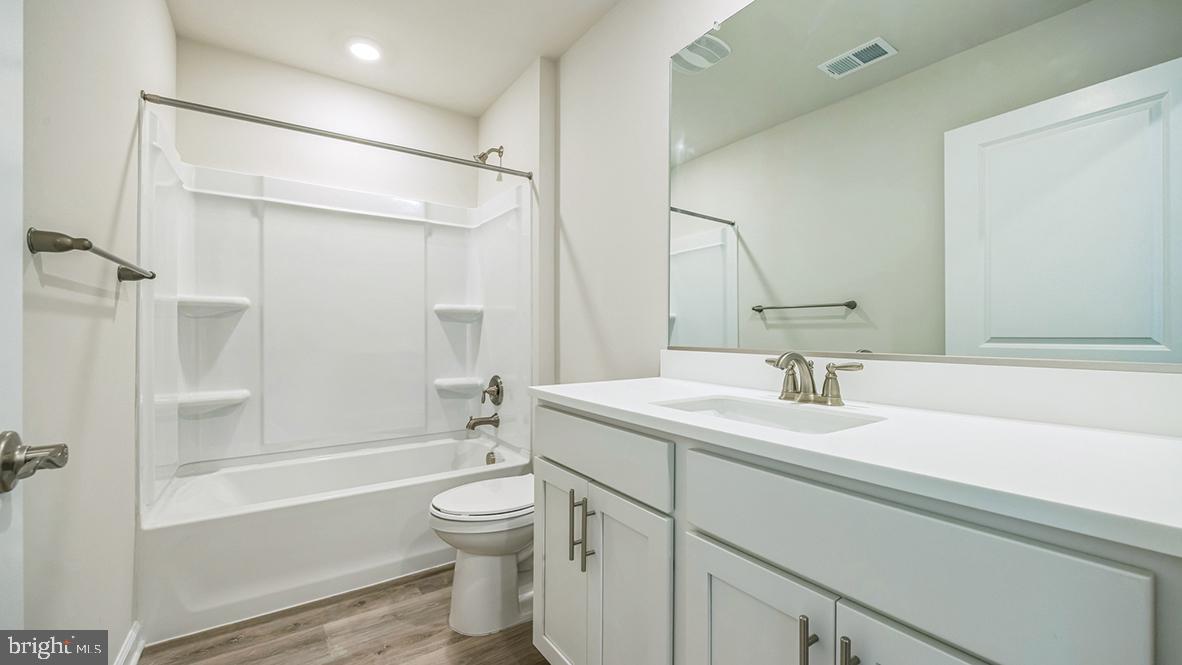 311 Vero Road Egg Harbor Township, NJ 08234 - Photo 23 of 27 a bathroom with a sink toilet vanity and shower