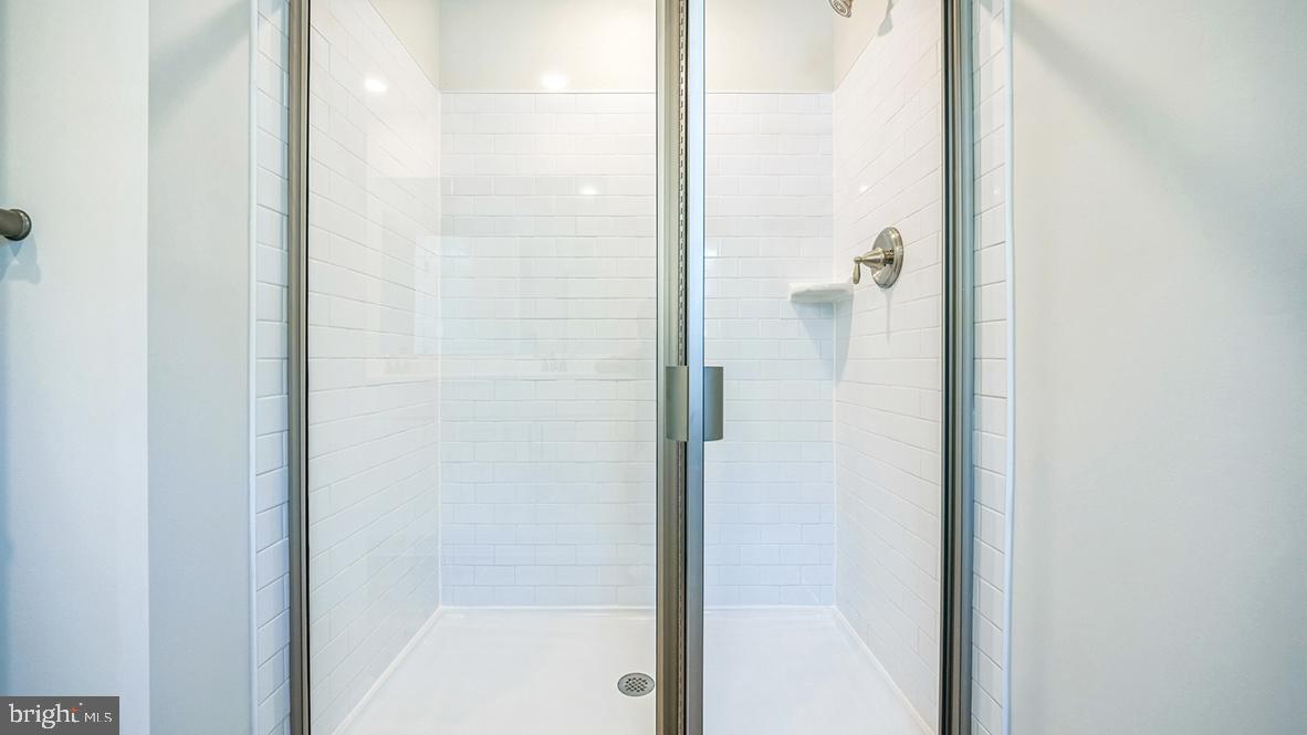 311 Vero Road Egg Harbor Township, NJ 08234 - Photo 24 of 27 a bathroom with a glass shower door