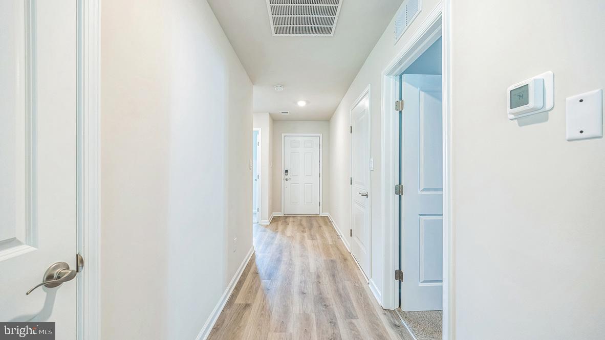 311 Vero Road Egg Harbor Township, NJ 08234 - Photo 8 of 27 a view of a hallway with wooden floor and staircase