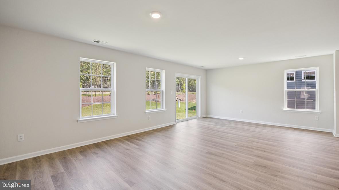 311 Vero Road Egg Harbor Township, NJ 08234 - Photo 10 of 27 an empty room with wooden floor and windows