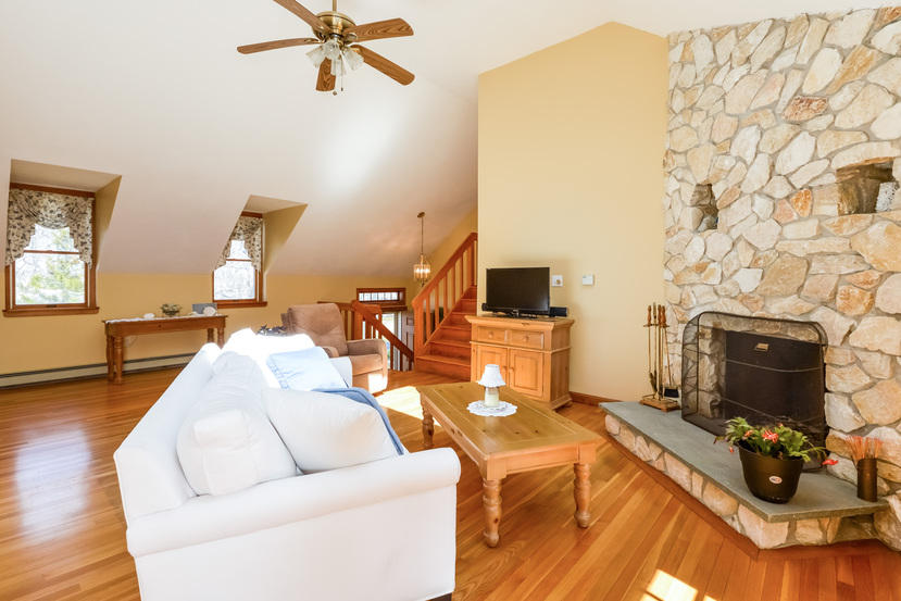 114 Elgin Road Pocasset, MA 02559 - Photo 10 of 34 a living room with furniture and a fireplace