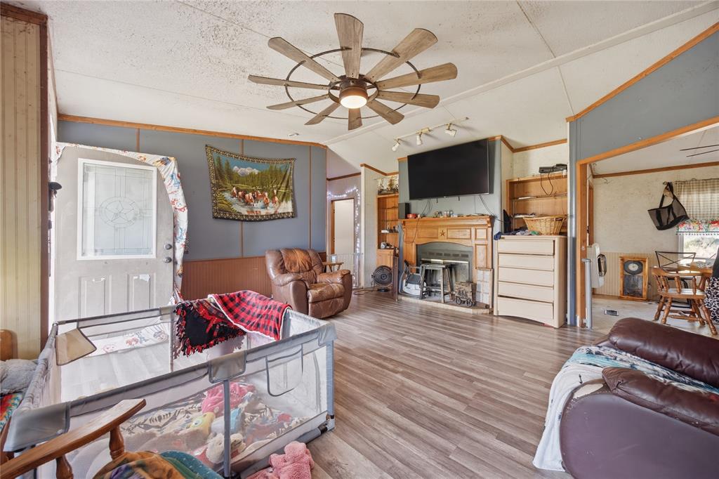2449 East Fm 120 Denison, TX 75021 - Photo 20 of 30 a living room with furniture a flat screen tv and a fireplace