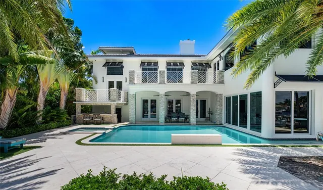 a view of a house with swimming pool and sitting area