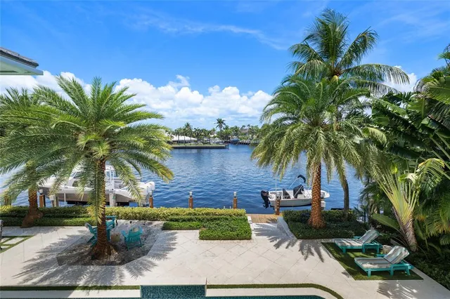 a living room with furniture a bookshelf and a wooden floor