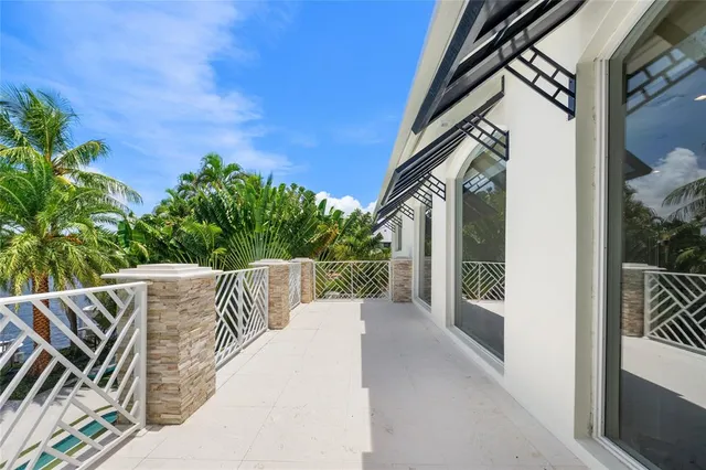 a bedroom with a bed a couch and a chandelier
