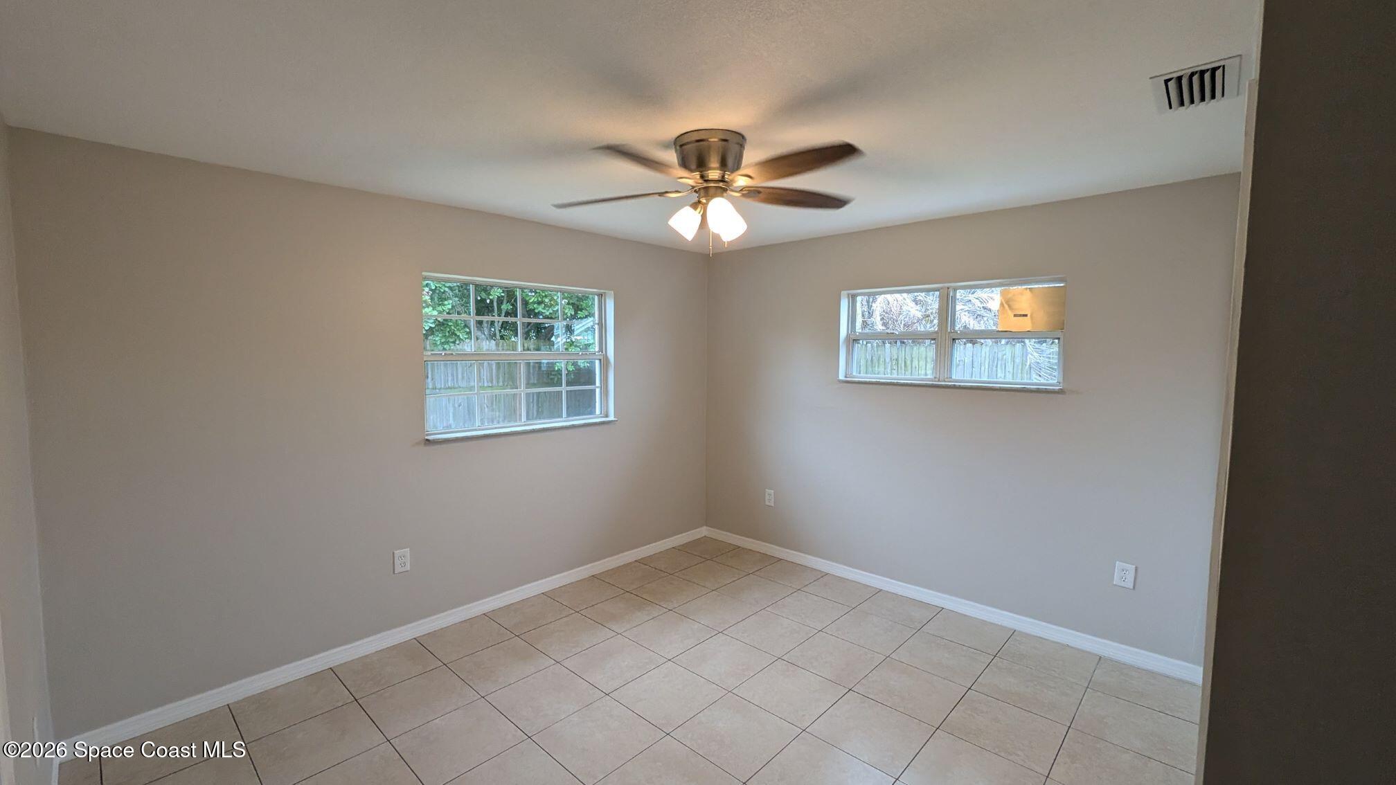 108 1st Street Merritt Island, FL 32953 - Photo 18 of 40 an empty room with windows and fan
