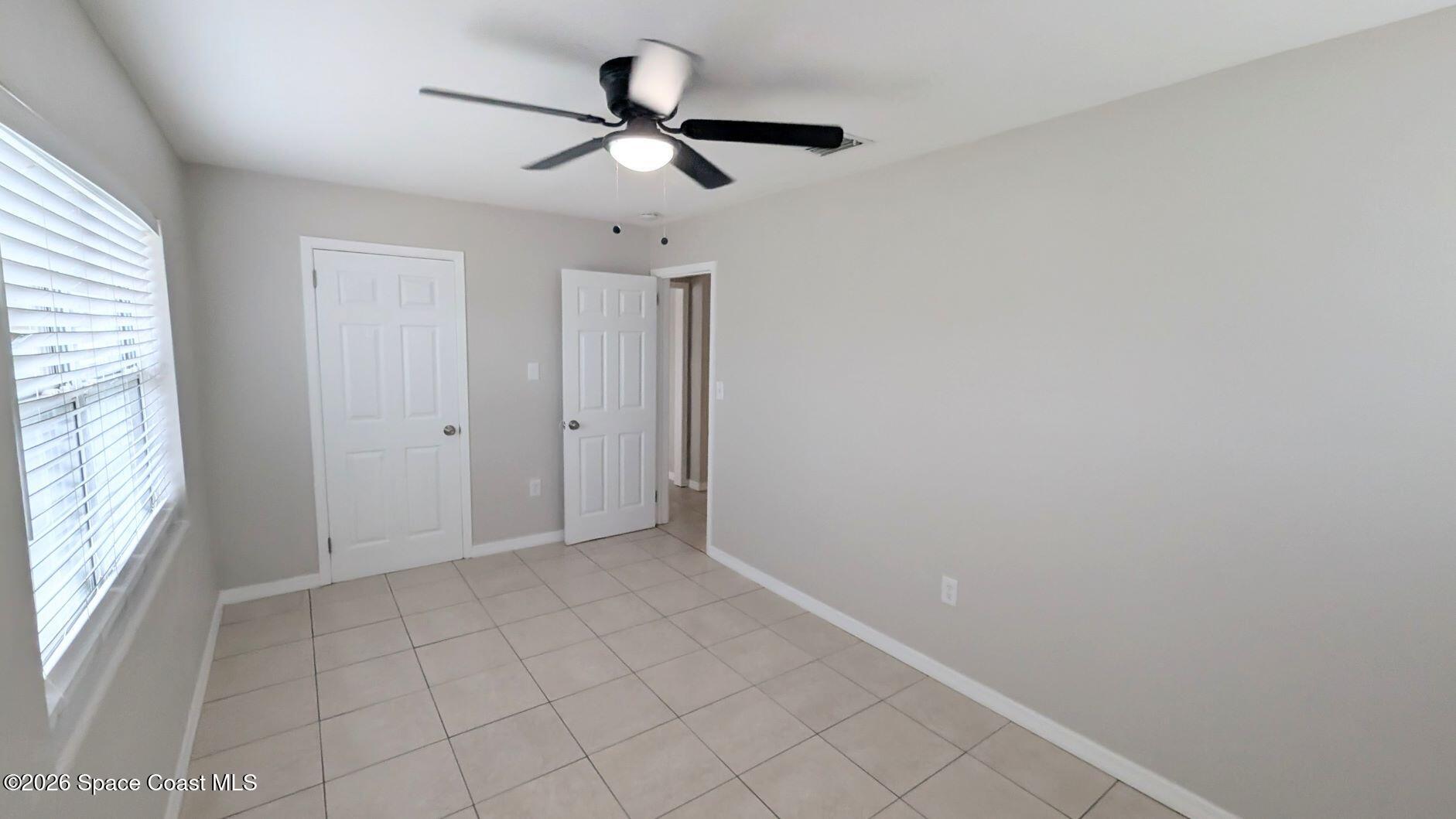 108 1st Street Merritt Island, FL 32953 - Photo 22 of 40 a view of a livingroom with a ceiling fan and window