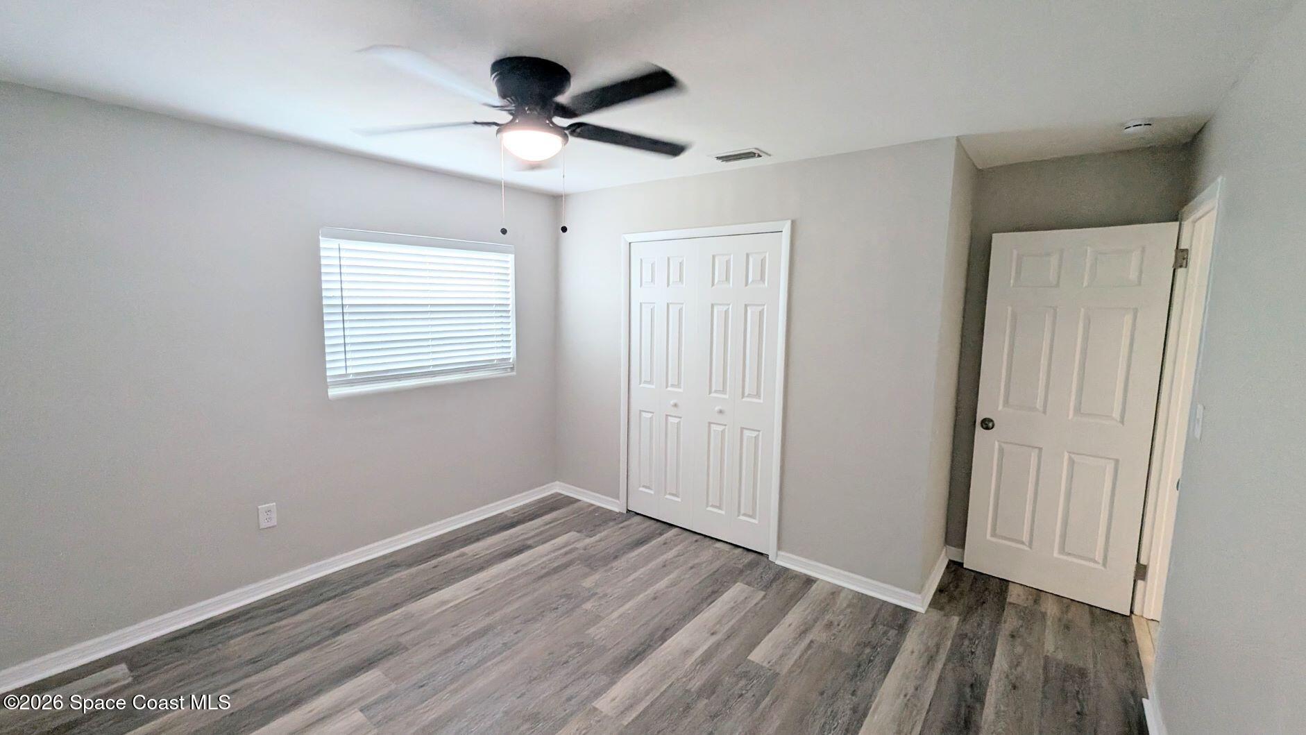 108 1st Street Merritt Island, FL 32953 - Photo 24 of 40 a view of an empty room with wooden floor and a window