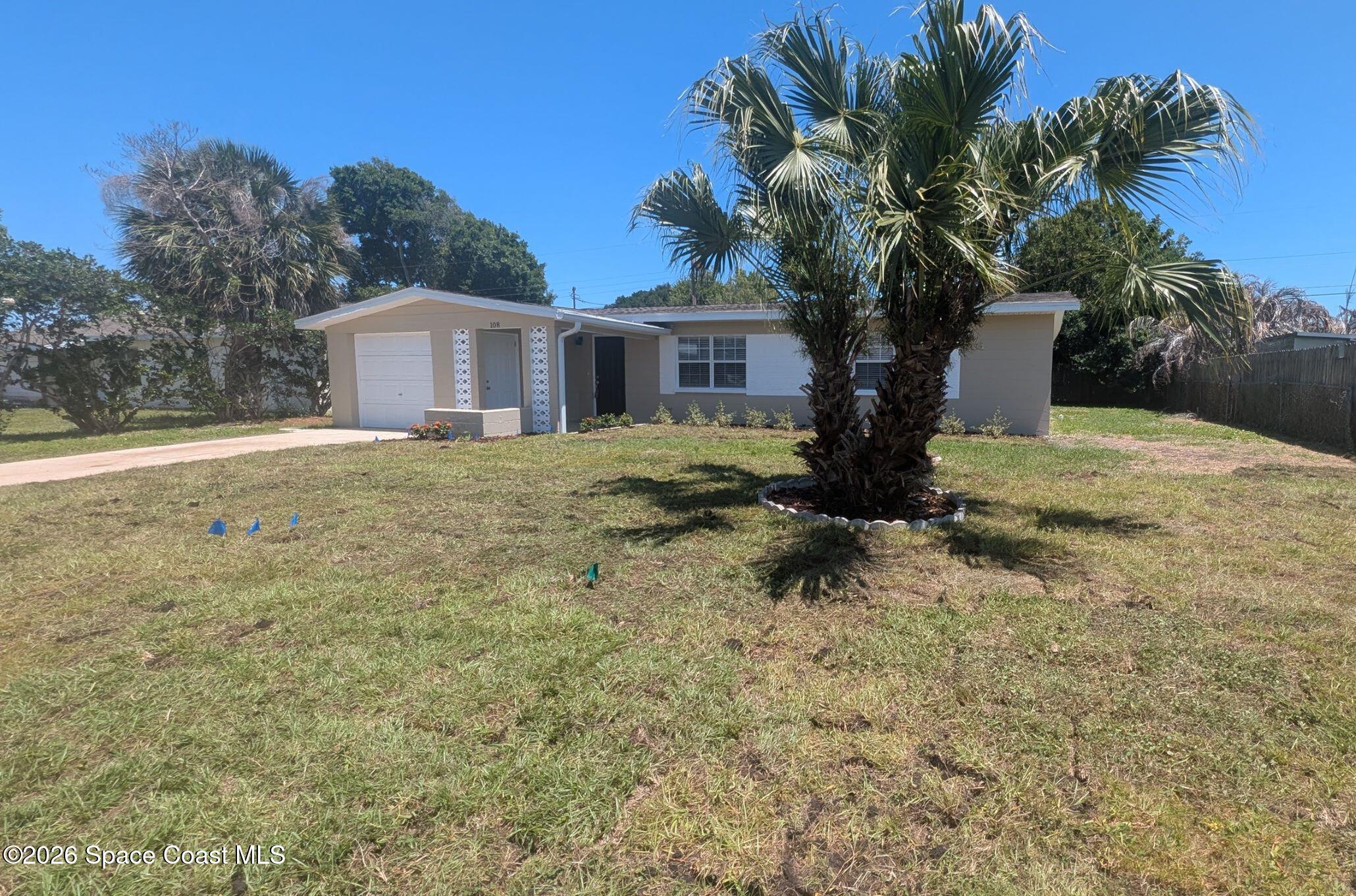 108 1st Street Merritt Island, FL 32953 - Photo 3 of 40 a big house with palm tree in front of it