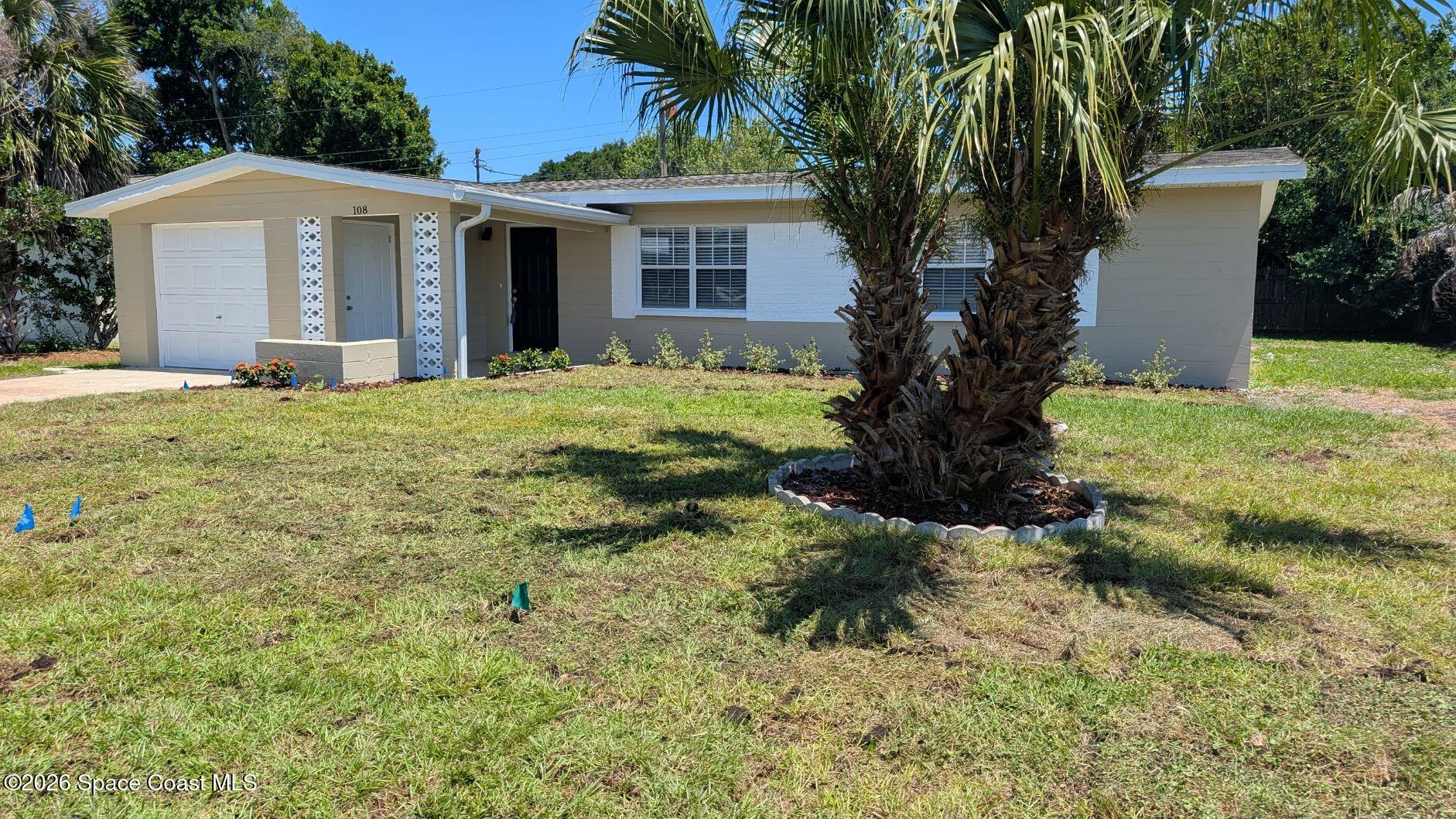108 1st Street Merritt Island, FL 32953 - Photo 5 of 40 a front view of a house with a yard