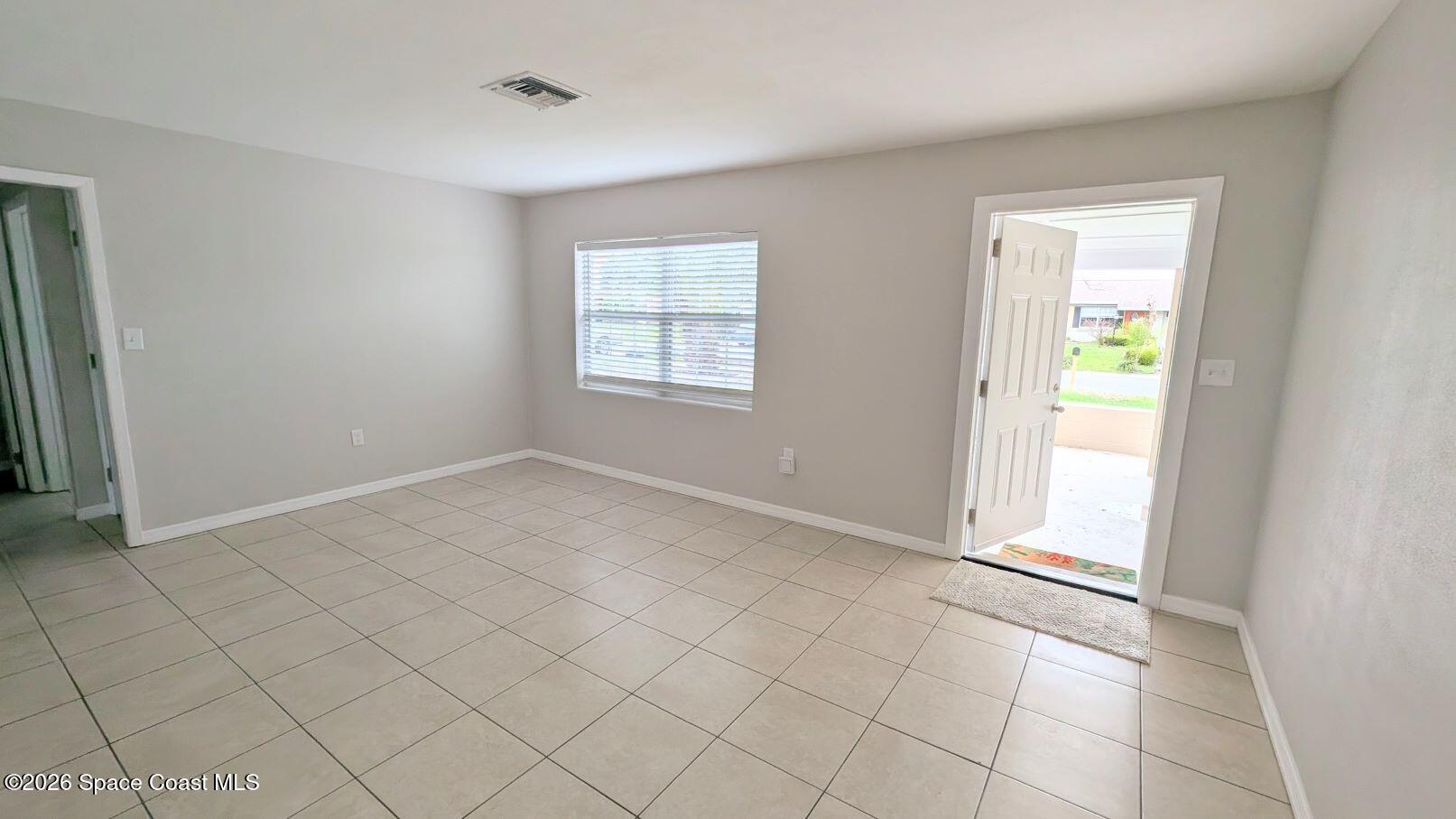 108 1st Street Merritt Island, FL 32953 - Photo 6 of 40 a view of an empty room with window