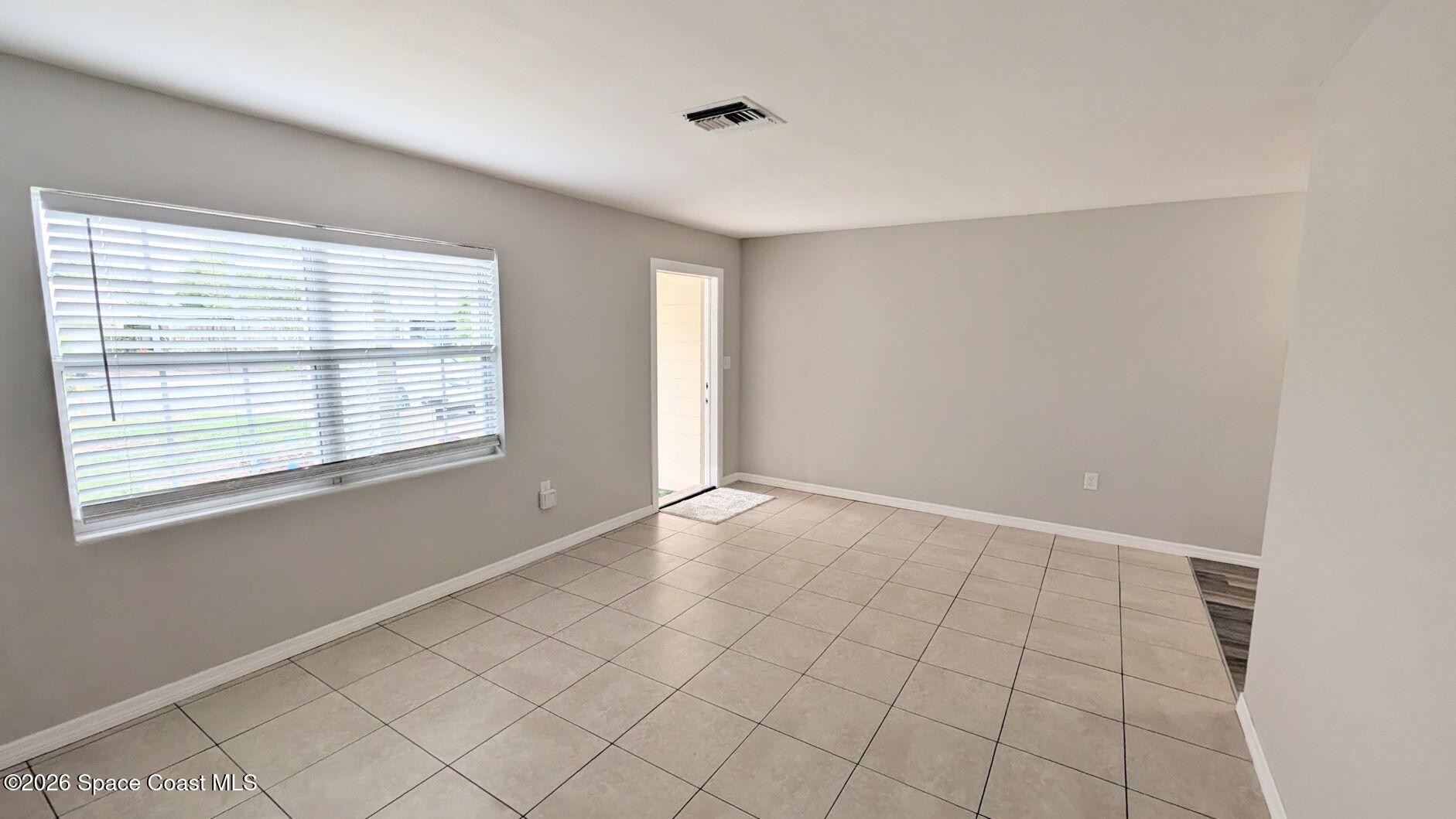 108 1st Street Merritt Island, FL 32953 - Photo 7 of 40 a view of an empty room with window