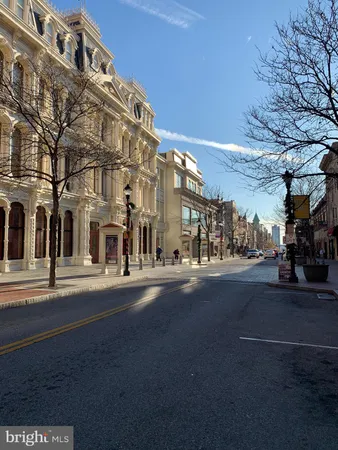 a city street lined with buildings and trees