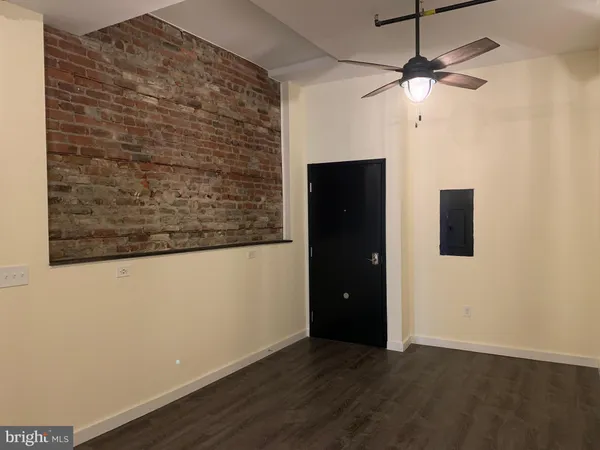 an empty room with a empty space and a ceiling fan