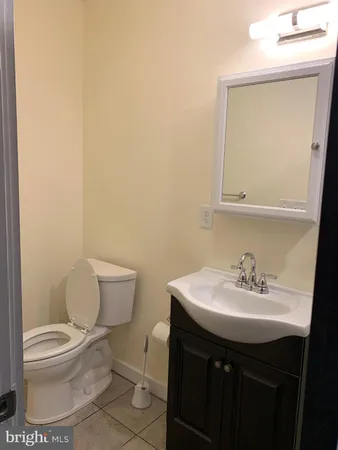 a bathroom with a sink toilet and a mirror