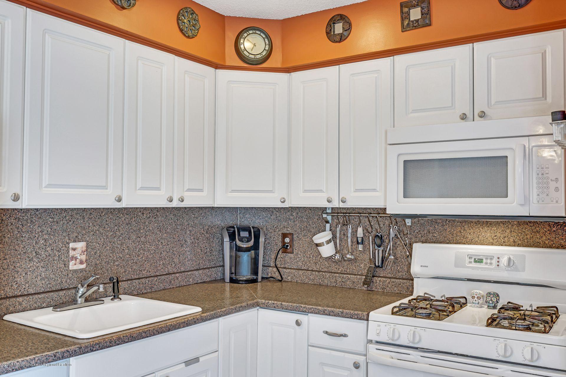 36 Mallard Road Bayville, NJ 08721 - Photo 11 of 28 a kitchen with a sink a stove and white cabinets