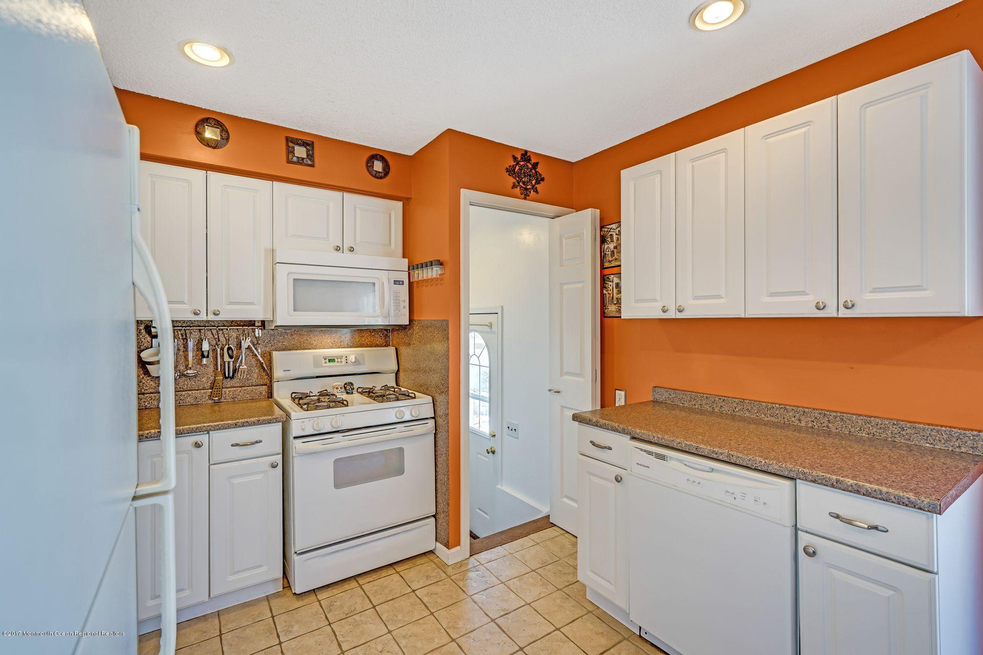36 Mallard Road Bayville, NJ 08721 - Photo 12 of 28 a kitchen with stainless steel appliances white cabinets and a refrigerator