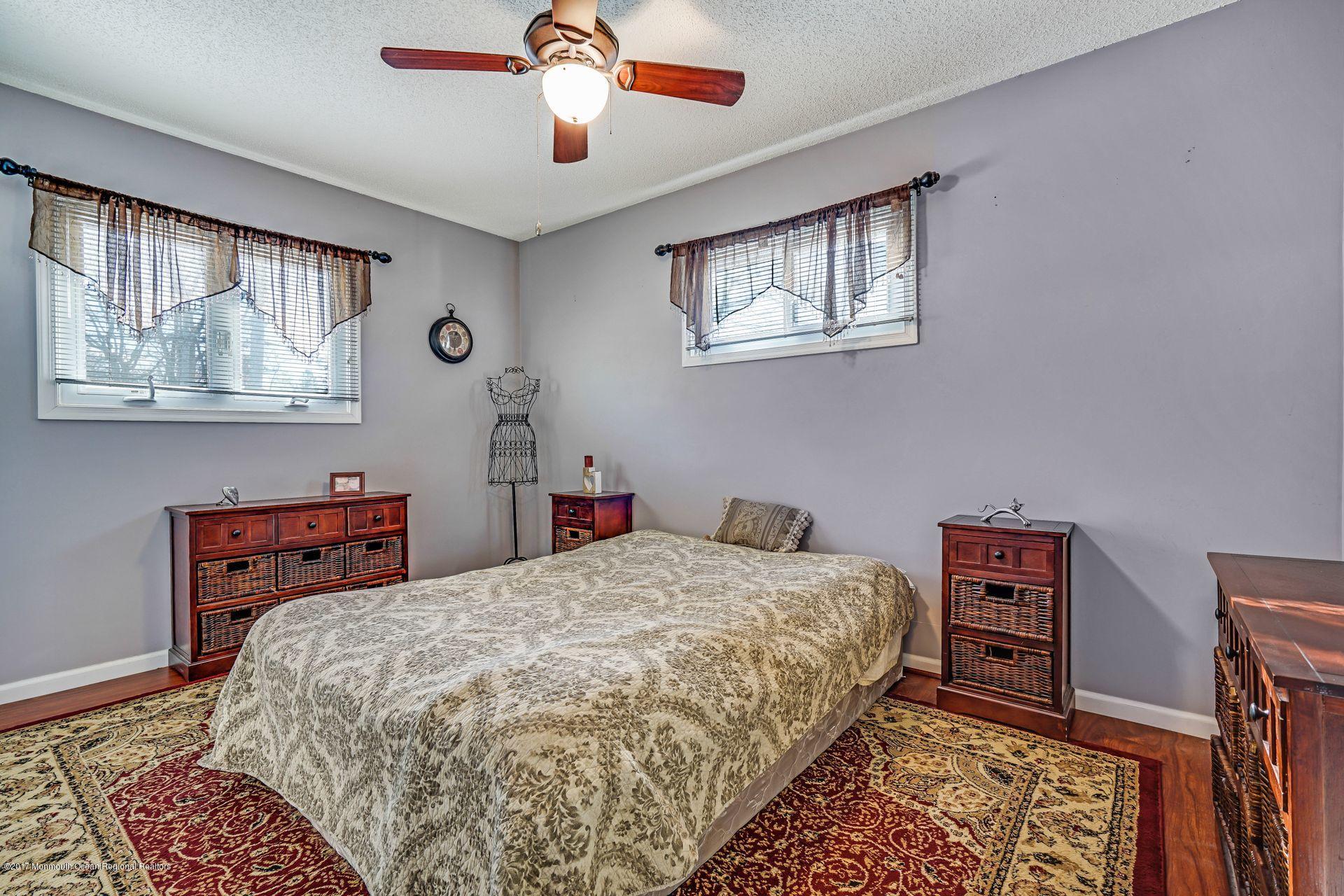 36 Mallard Road Bayville, NJ 08721 - Photo 16 of 28 a bedroom with a bed a dresser and chair