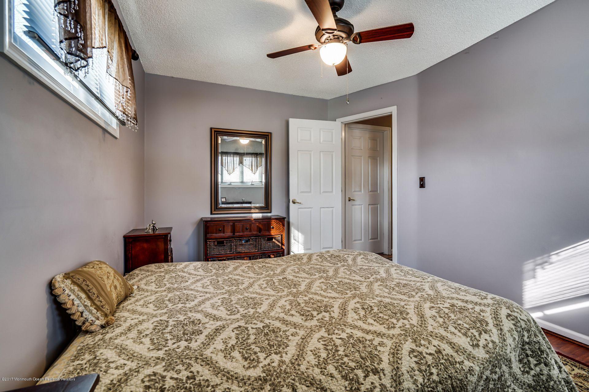 36 Mallard Road Bayville, NJ 08721 - Photo 17 of 28 a bedroom with a bed and a chandelier