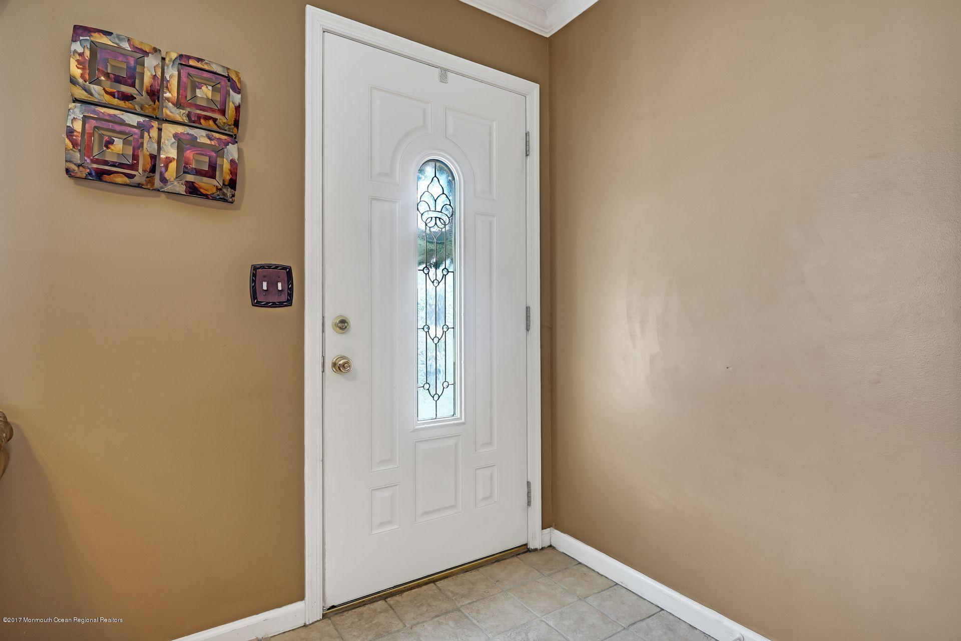 36 Mallard Road Bayville, NJ 08721 - Photo 2 of 28 a view of a hallway with paintings on the wall