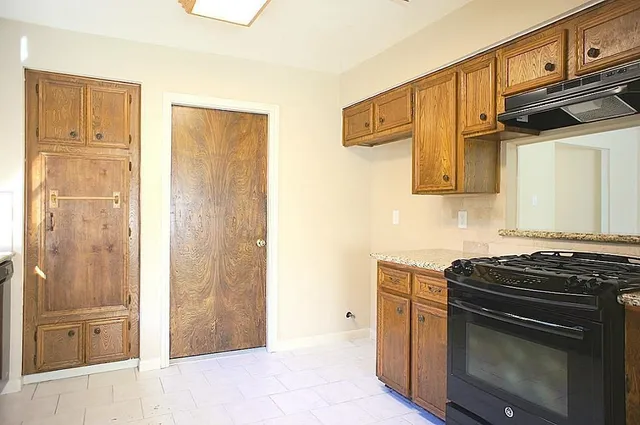 a bathroom with a granite countertop sink a mirror and a shower