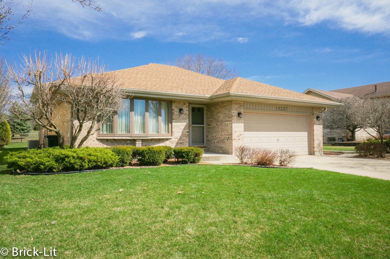 a front view of house with yard and green space