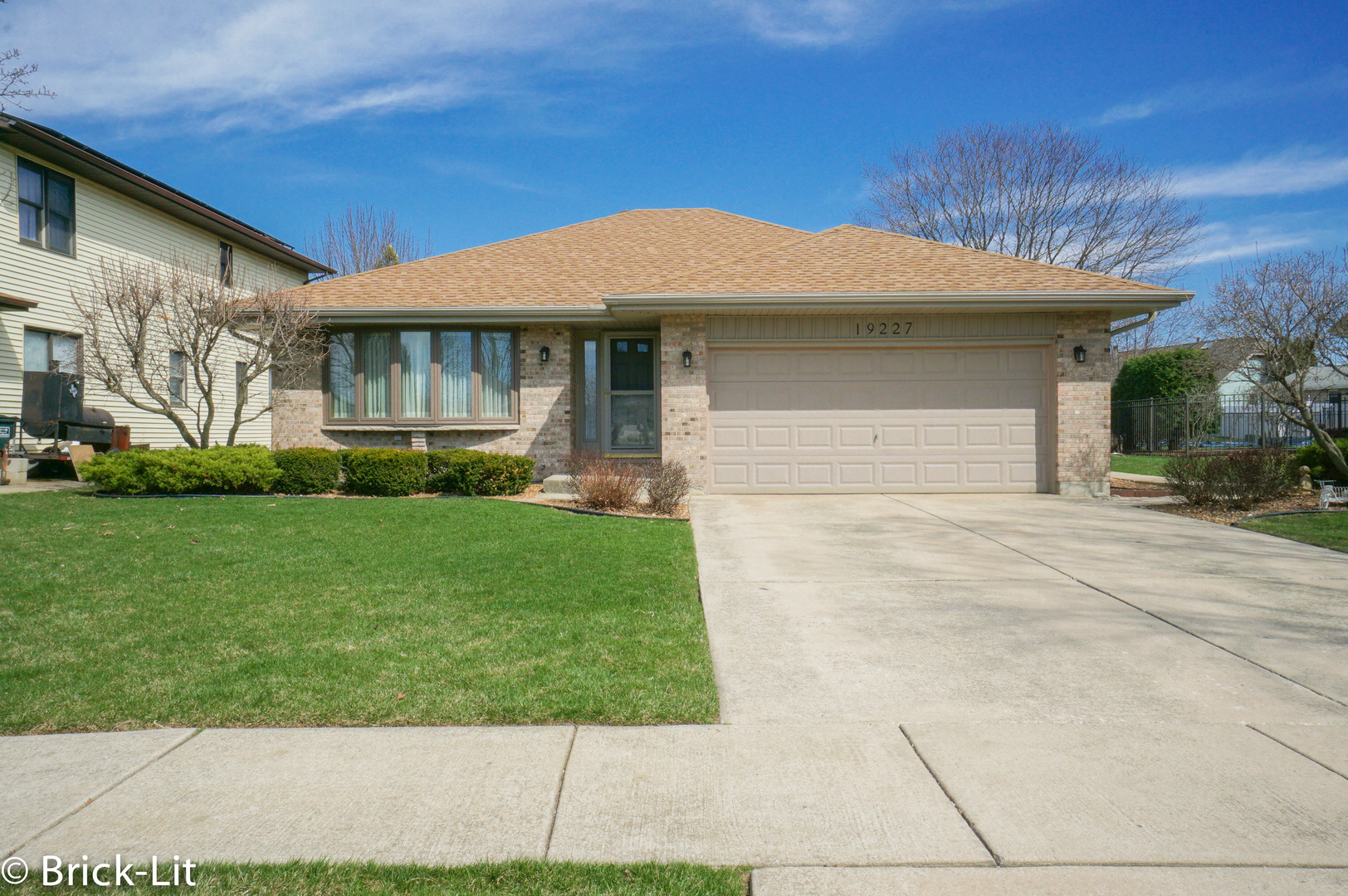 19227 Weber Road Mokena, IL 60448 - Photo 2 of 19 a front view of a house with a garden and plants