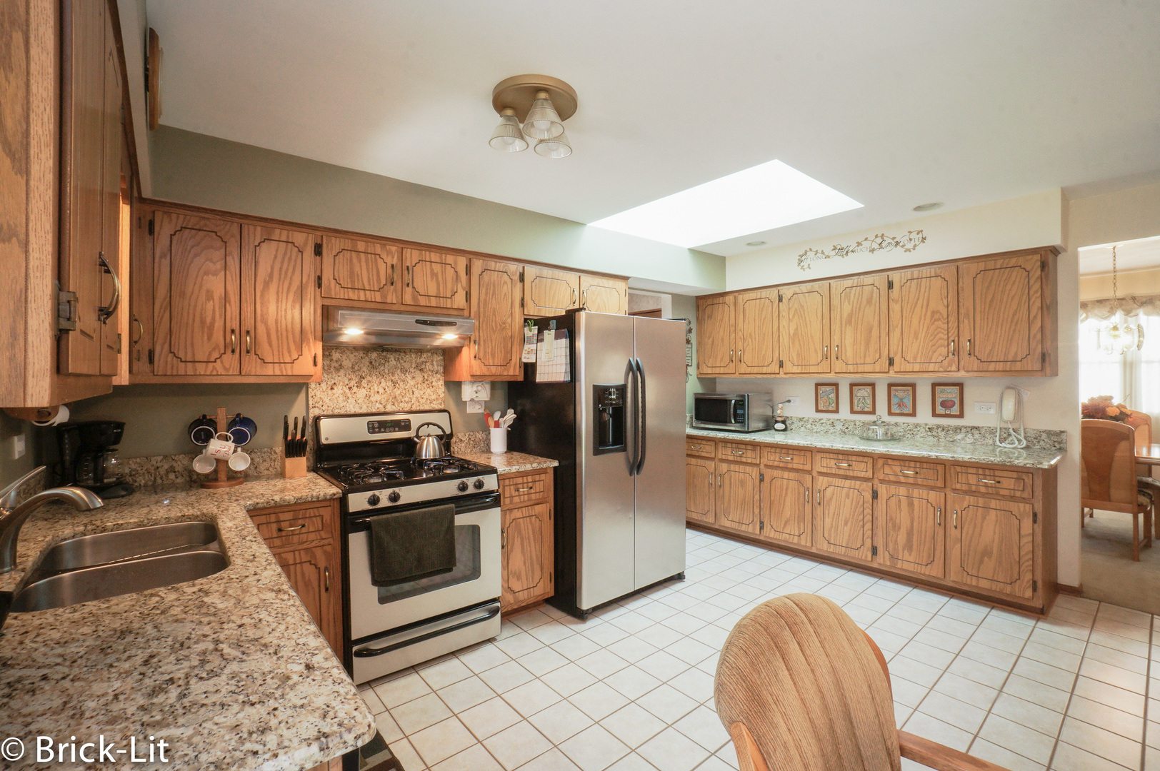 19227 Weber Road Mokena, IL 60448 - Photo 9 of 19 a kitchen with stainless steel appliances granite countertop a stove refrigerator sink and cabinets