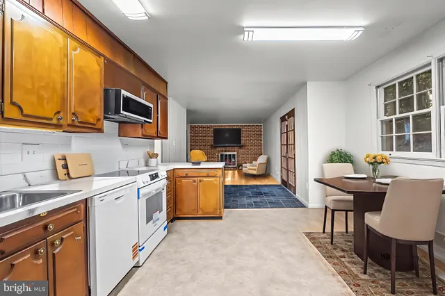 a kitchen that has a sink and a stove in it
