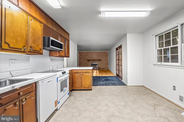 a kitchen with stainless steel appliances granite countertop a stove and a refrigerator