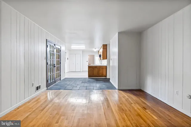 a view of a hallway with wooden floor