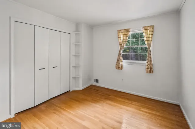 a bathroom with a granite countertop sink toilet and mirror