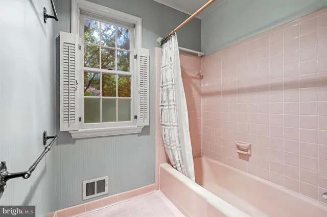 a bedroom with a bed couch and a view of living room
