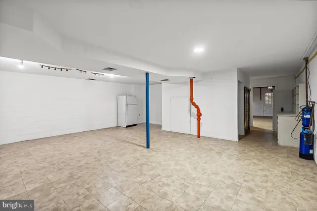 a view of a house with a yard and large tree