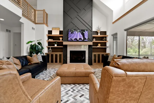 a spacious bedroom with a bed and a flat screen tv