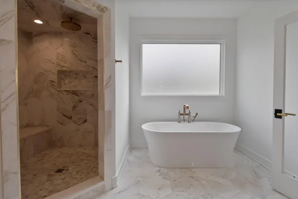 a bathroom with a sink a toilet a mirror and shower
