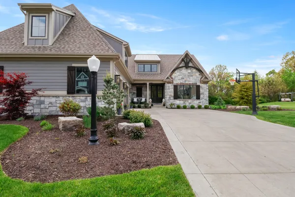 a front view of a house with a garden