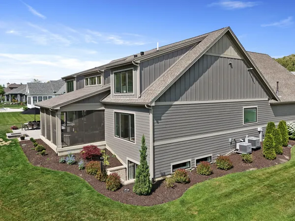 a kitchen with stainless steel appliances granite countertop wooden floors stove and white cabinets