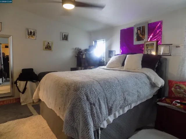 a bedroom with a bed and lamp