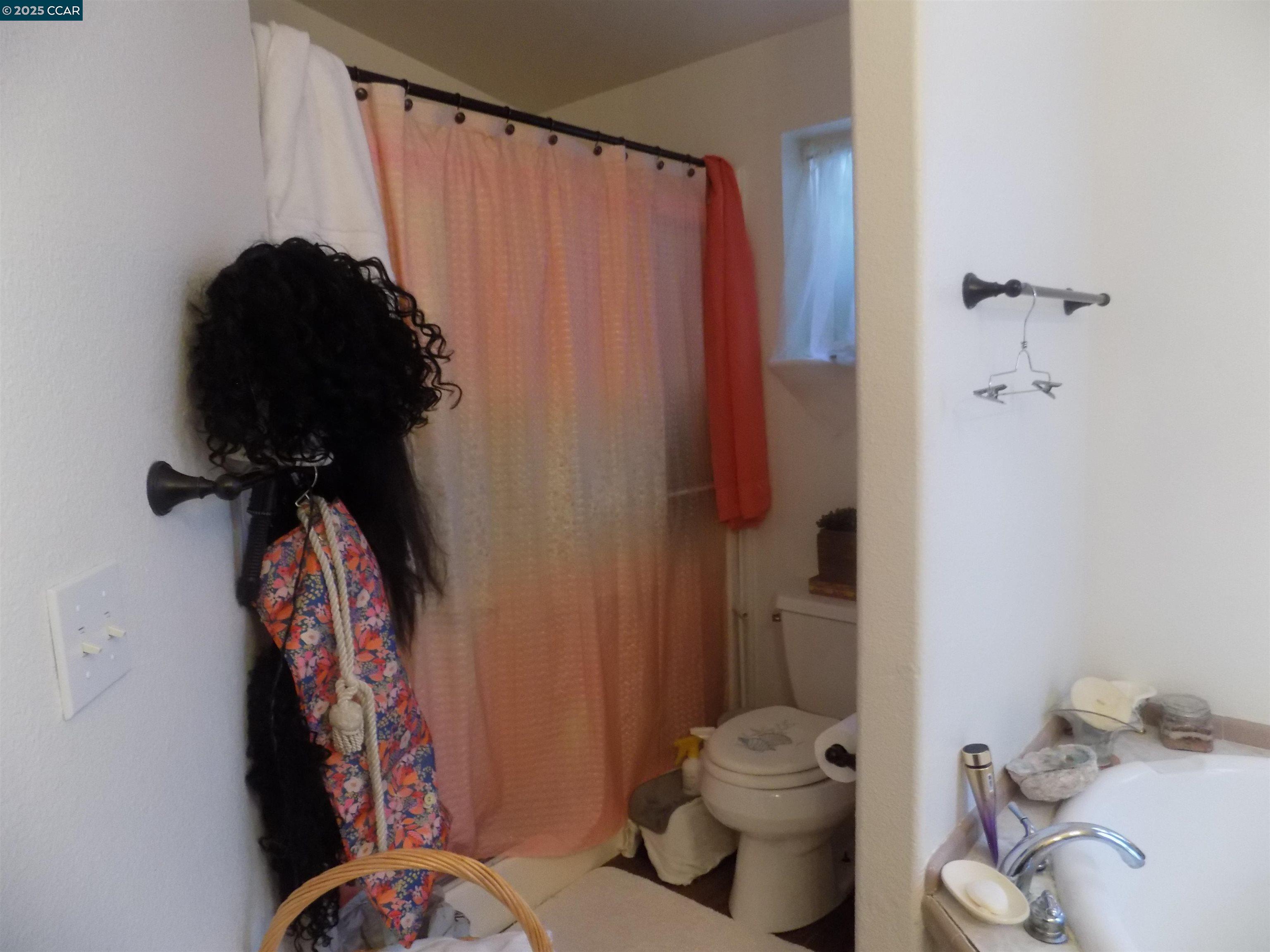 55 Pacifica Avenue, Unit 146 Bay Point, CA 94565 - Photo 18 of 18 a bathroom with a toilet and a shower curtain